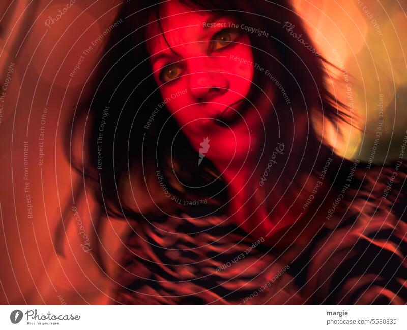 A woman celebrates in party light Woman Face Human being portrait Eyes Feminine dancing Movement Red light Hair and hairstyles Looking celebrations Young woman