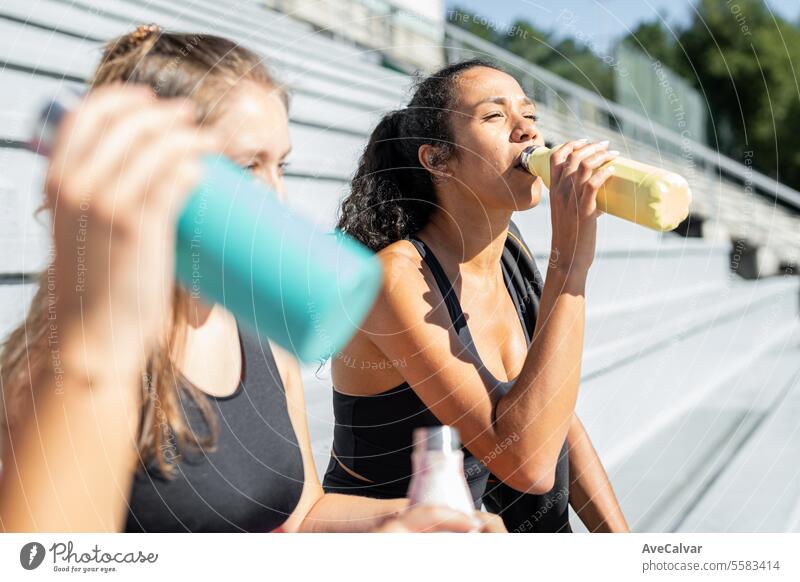 Girl drinking water from a thermos after doing exercise. Resting before do another training series. person lifestyle fitness sport healthy female young