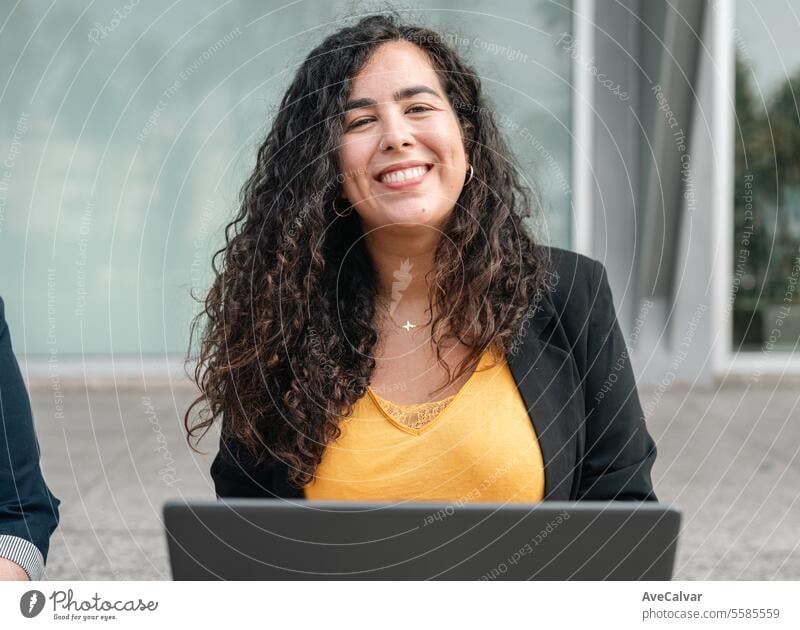 Smiling young hispanic business woman leader entrepreneur, professional manager smiling on street outdoors colleague female women person laptop computer happy