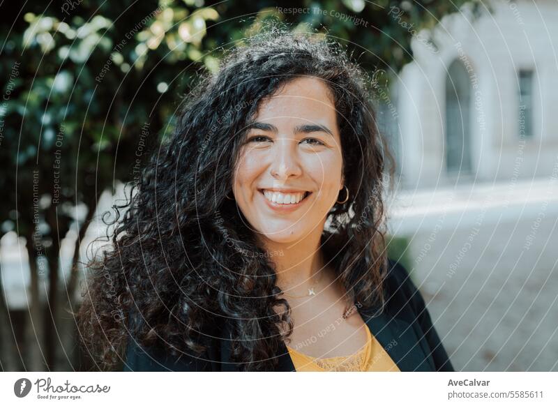 Smiling young hispanic business woman leader entrepreneur, professional manager smiling on street businesswoman office colleague person portrait adult beauty