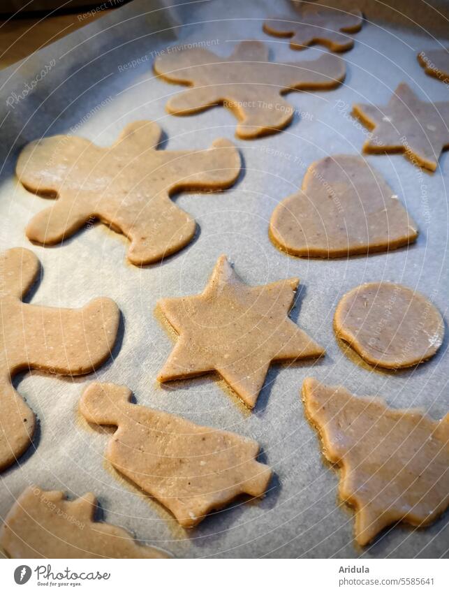 Raw cookies on a baking tray with baking paper Cookie dough cookie dough Baking cut out cookies Christmas & Advent Christmas biscuit pre-Christmas period Stars