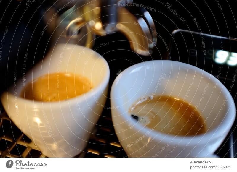 Two espresso cups getting filled in a portafilter machine Stock Photo -  Alamy