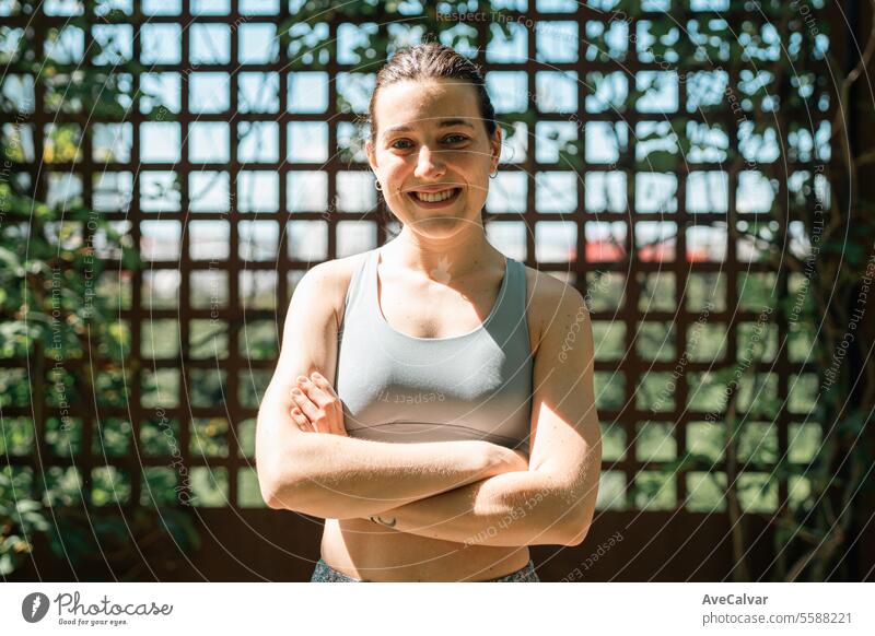 Smiling athletic girl doing series of exercises with a medicine