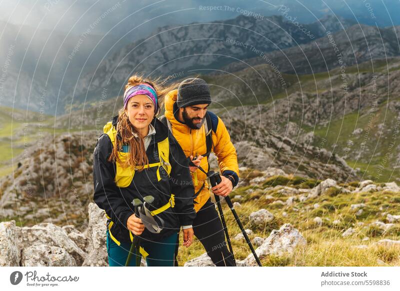 people trekking in the mountains woman adult caucasian hike route sport hiker rain travel nature grass landscape couple happy friends lifestyle vacation healthy