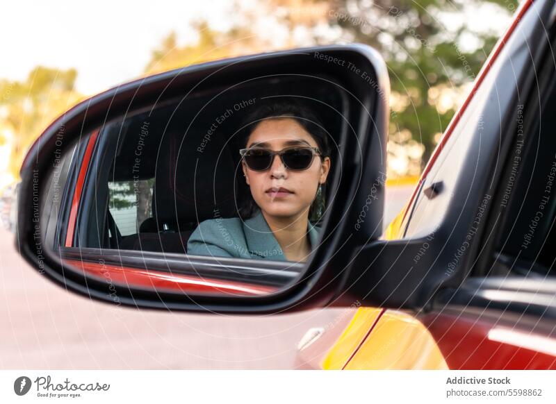 Beautiful employee in sunglasses reflecting in mirror woman side view mirror reflection car pretty young serious businesswoman confident beautiful