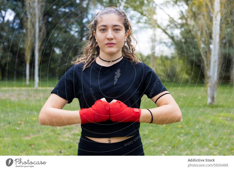Boxer woman with hands red bandage wrap for boxing outdoors adult art athlete background black body boxer defense determination equipment ethnicity exercise