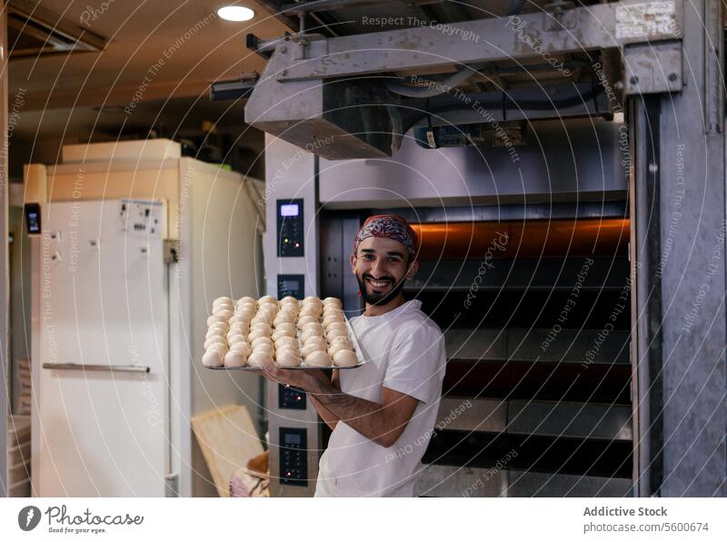 Arabic baker with tray with dough balls arabic bakery fresh raw bread happy smile making oven food pastry white bun bakehouse production flour tasty cuisine