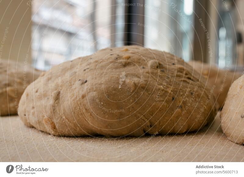 Loaf-shaped bread dough on the table loaf bakehouse bakery wheat oven hot factory production food fresh tasty industry preparing flour workplace pastry