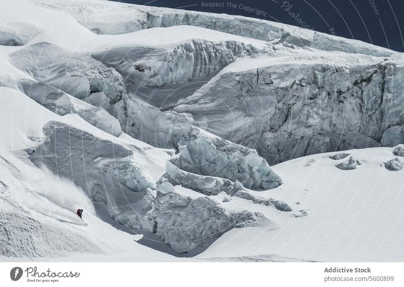 High angle of unrecognizable person skiing on snow mountain during vacation at Swiss Alps during sunny day skier enjoy winter covering swiss alps from above