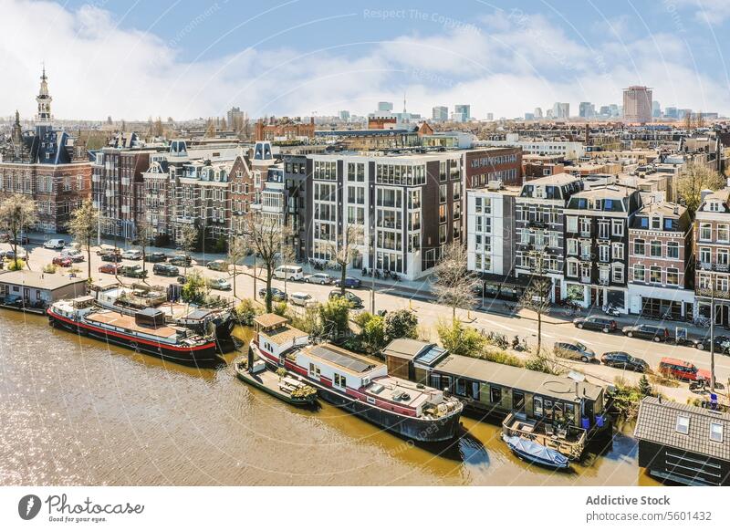 Ships and boats on river against cityscape ship building aerial view sunny road tree water architecture residential car exterior window flat apartment house