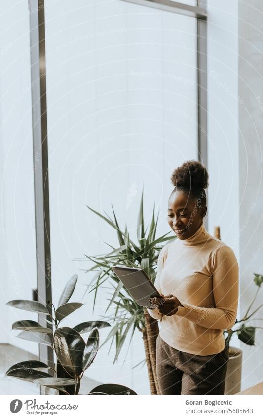 African American business woman standing in front of her team in office - a  Royalty Free Stock Photo from Photocase