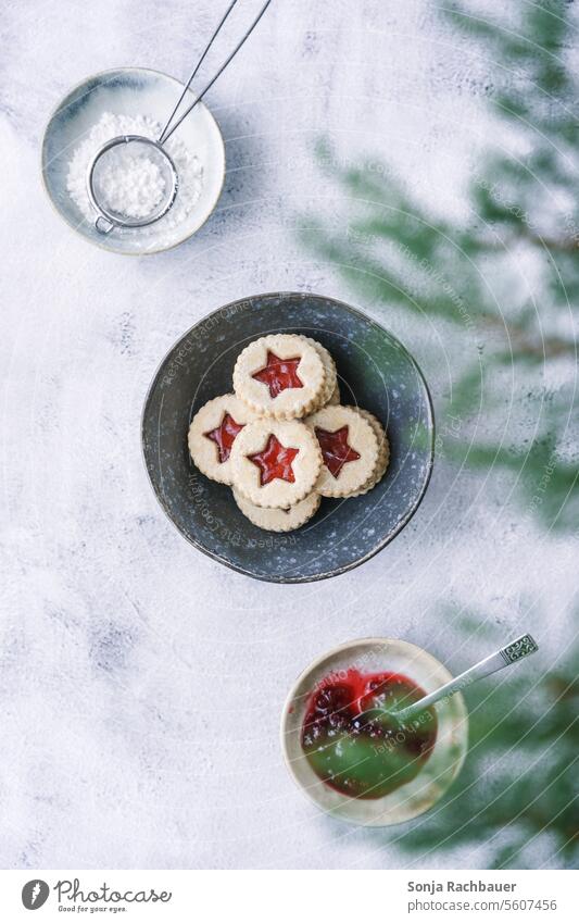 Shortcrust cookies with strawberry jam in a bowl. Top view. Christmas biscuit Cookie Strawberry jam Christmas & Advent Dessert baked cute cut out cookies