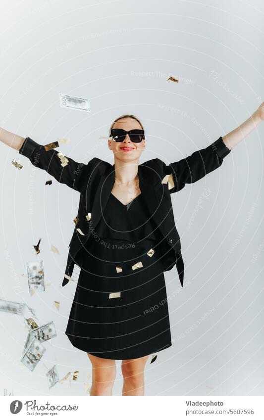 Lucky Woman winner wearing black suit and sunglasses happy with dollars and confetti falling around woman lucky money flying business excited lady rich finance