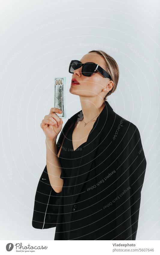 Woman with dollars in hand. Luxury, beauty woman in black suit and sunglasses money luxury business holding banknotes portrait currency cash female adult young