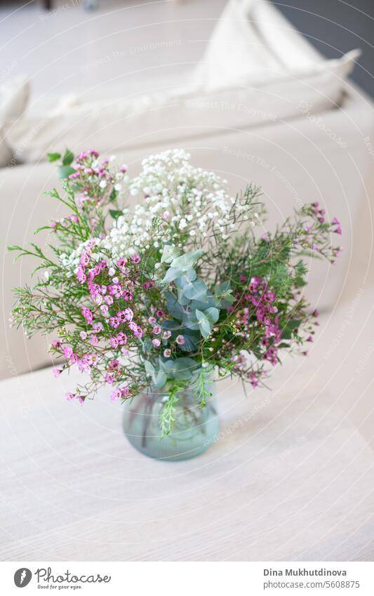 beautiful pink wax flower bouquet  on white beige neutral background copy space top and bottom. Floral arrangement vertical backdrop. flowers Flower Decoration