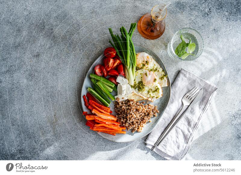 Healthy Breakfast Plate with Vegetables, Cheese and Eggs wit Pesto breakfast healthy ingredients raw vegetables cherry tomato mini cucumber green onion