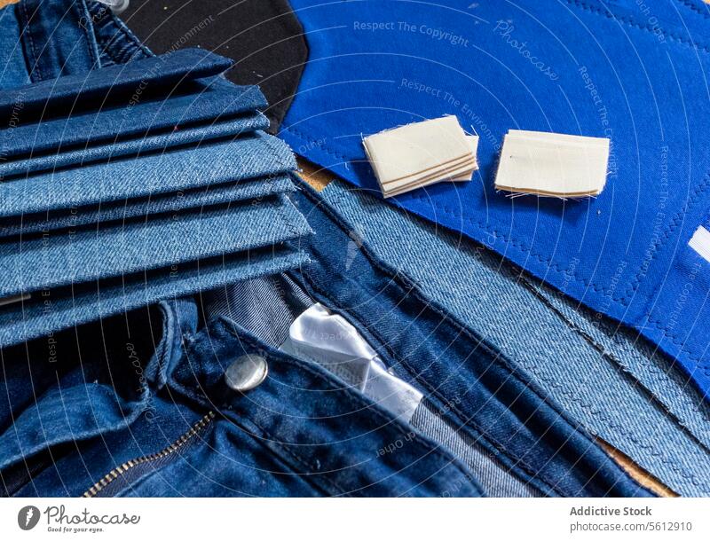 Assorted denim materials and patches for sewing projects fabric textile garment repair blue jeans zipper creative endeavor close-up assorted layout crafting diy