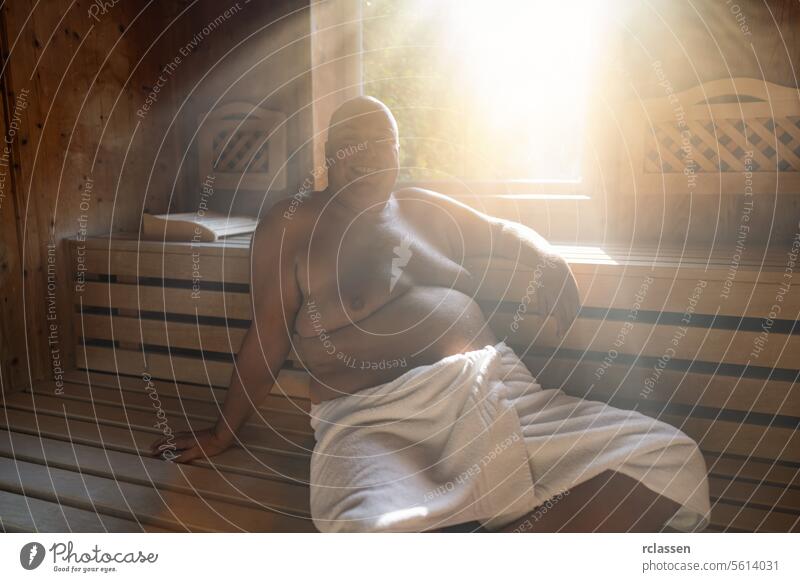 Man Relaxing in a Traditional Finnish Sauna wellness spa resort hotel window sweat finland finnish man in sauna smiling finnish sauna relaxation towel