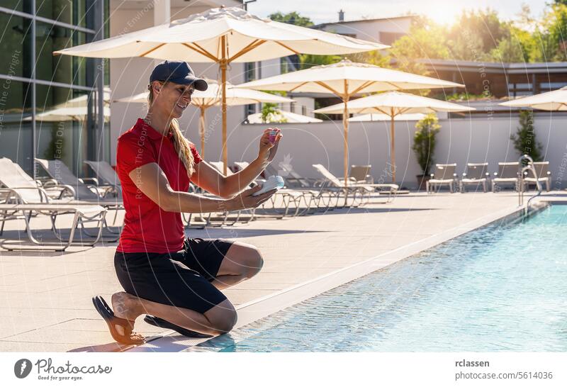 Lifeguard smiling while conducting pool water quality test hotel ph testing investigate monitoring filtration clean service system lifeguard water test