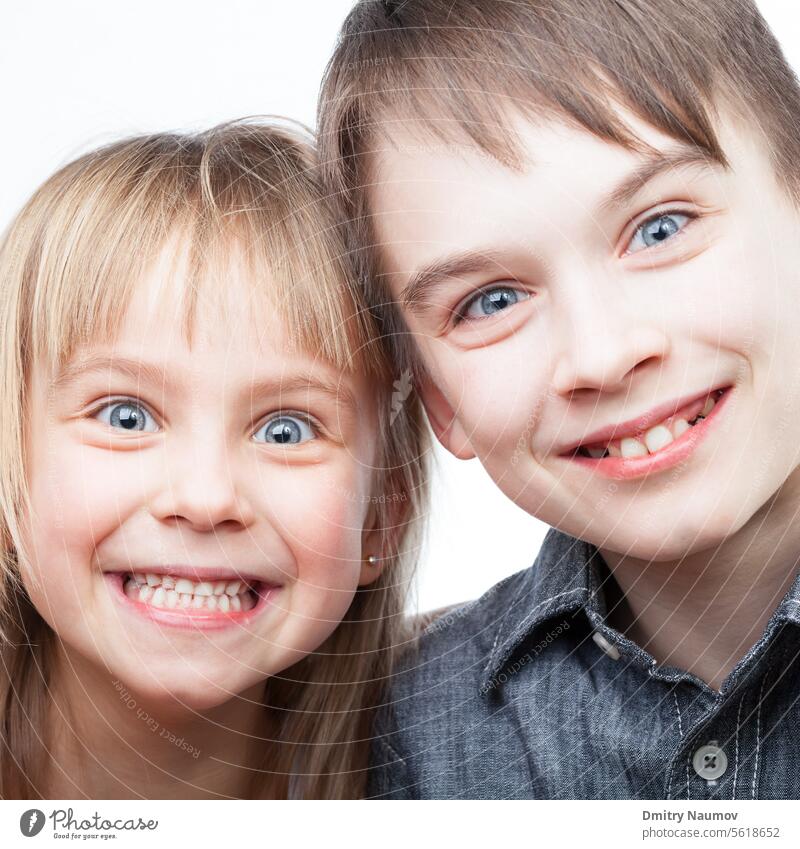 Happy siblings Brown Hair Expressing Positivity Looking At Camera blonde blue eyes boy brother caucasian cheerful child childhood cute emotion expression face