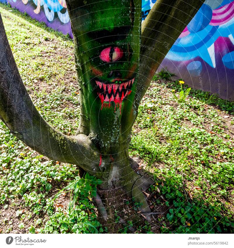 Bloodthirsty tree in the sunshine Tree trunk bark graffiti Drawing Bizarre Monster Whimsical Creepy Hallowe'en Eyes Mouth creep Dangerous Fear Face Teeth