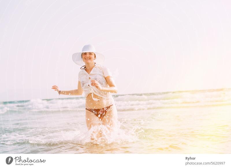 Happy Beautiful Girl On Beach Vacation. Bright Summer. Young, Pretty Lady Relaxing In Vacation. Active Caucasian Young Woman In Sea Ocean. Happy Seaside Vacation. Beach Vacation Concept