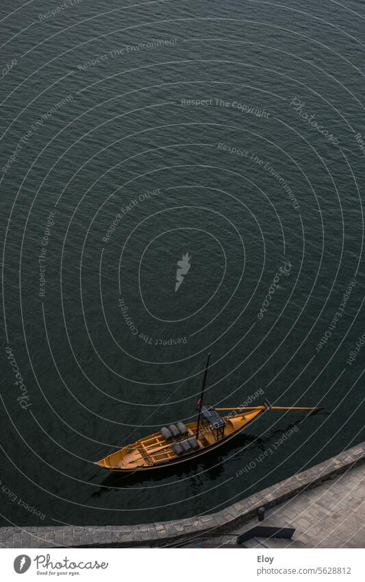 wooden boat, aerial shot of a small yellow wooden sailboat moored in a dark water Water Wood boats Sport boats vacation Harbour Maritime ship Navigation Ocean