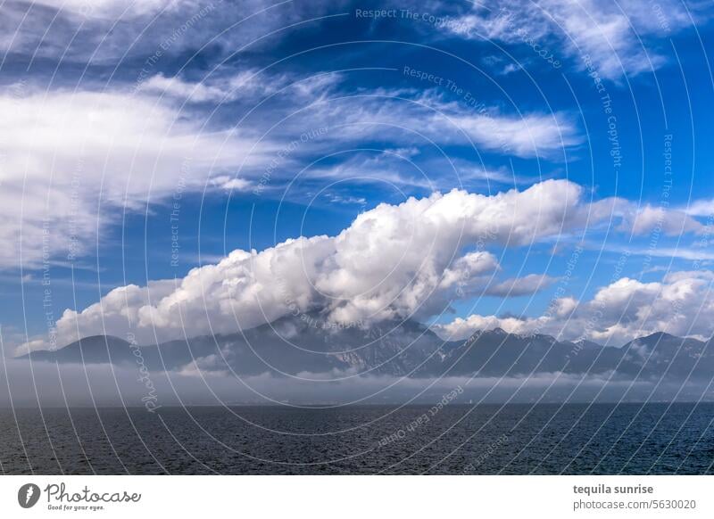 Clouds over Lake Garda cloud Clouds in the sky Mountain mountains bank Shore line Garda Mountains Volcano Water Sky Blue Blue sky