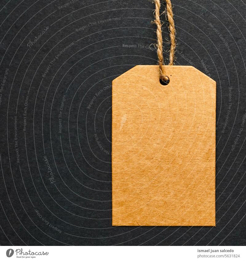 Empty brown paper tag tied with white string. Price tag, gift tag - a Royalty  Free Stock Photo from Photocase