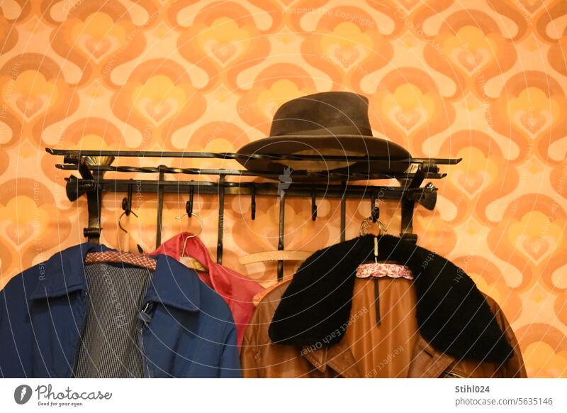 60s wardrobe with hat rack Hat rack wrought-iron Black tawdry Men's hat Jacket Coat Hanger Checkmark Collar Fur collar Interior shot Retro Living or residing