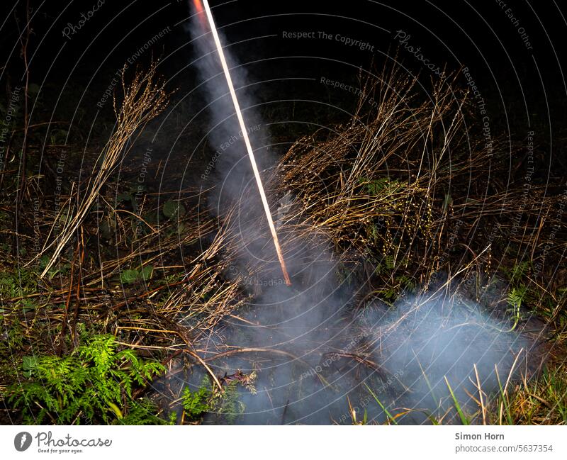 Launching a rocket in a field Rocket launch New start initiation Ritual New Year's Eve New Year's rocket Environmental pollution Noise Bang bang Smoke Fuse