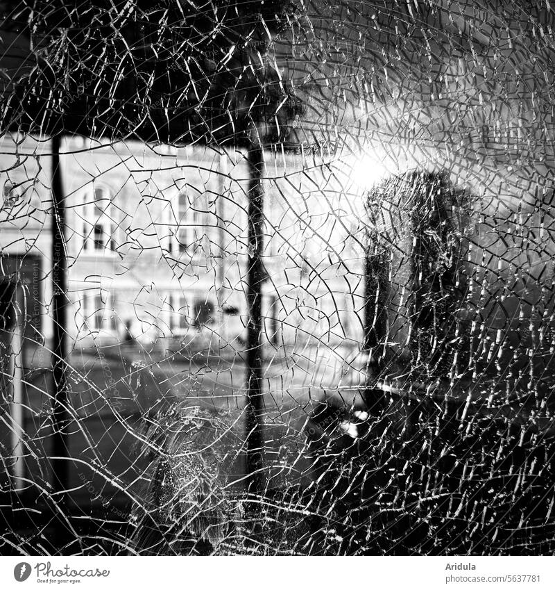 Cracks in a pane of glass in front of a house facade Glass cracks Slice Pane Broken Window Destruction Vandalism Damage Structures and shapes Aggression Force