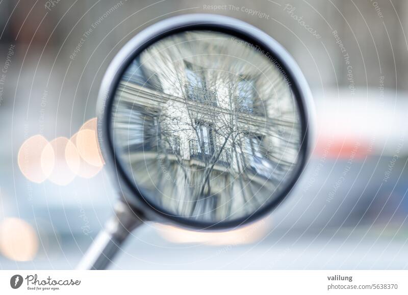 Reflections in a rearview mirror of a motorcycle conceptual detail focus mirror reflection rear view road tourism transport travel vehicle window