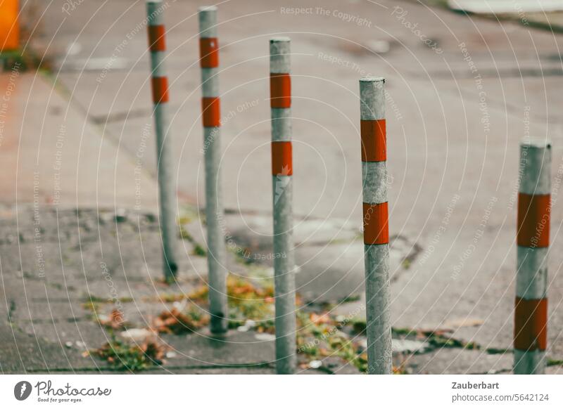 A row of posts with red stripes on the sidewalk Pole stake Bollard Stripe Red off Street Pattern Row Line Beaded Stand Unwavering walkway Protection lock Safety