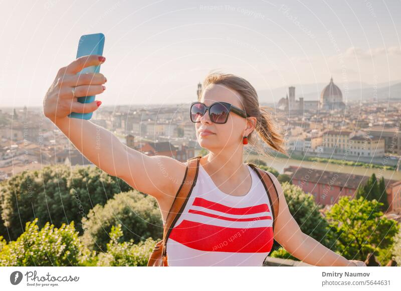 Tourist taking selfie with Florence cityscape Tuscany Italy Photographing camera distant european evening firenze florence girl holiday italian lifestyle