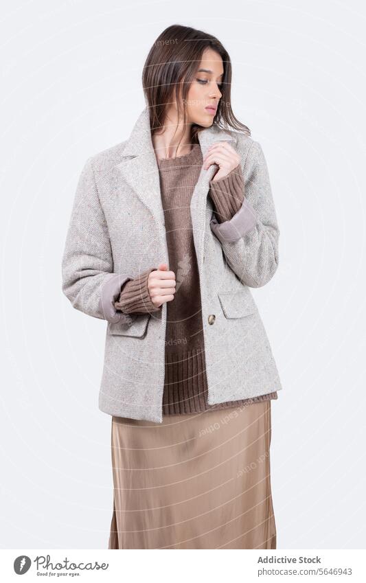 Charming woman in gray blazer in white studio Woman Jacket Model Style Trendy Confident Appearance Elegant Apparel Garment Outfit Female Modern Young Feminine