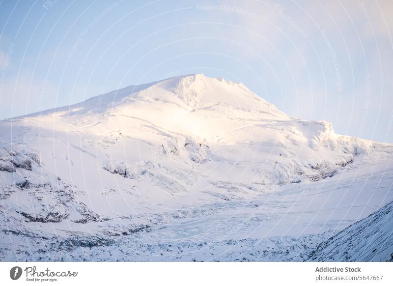 Snow-covered mountain peak under a clear sky in Iceland iceland snow sunlight serene landscape majestic blue outdoor nature scenic cold winter white frost