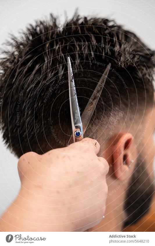 Cropped unrecognizable female hairstylist hands cutting male client's hair with scissors at salon Hairdresser Scissors Cut Comb Man Salon Care Service Haircut