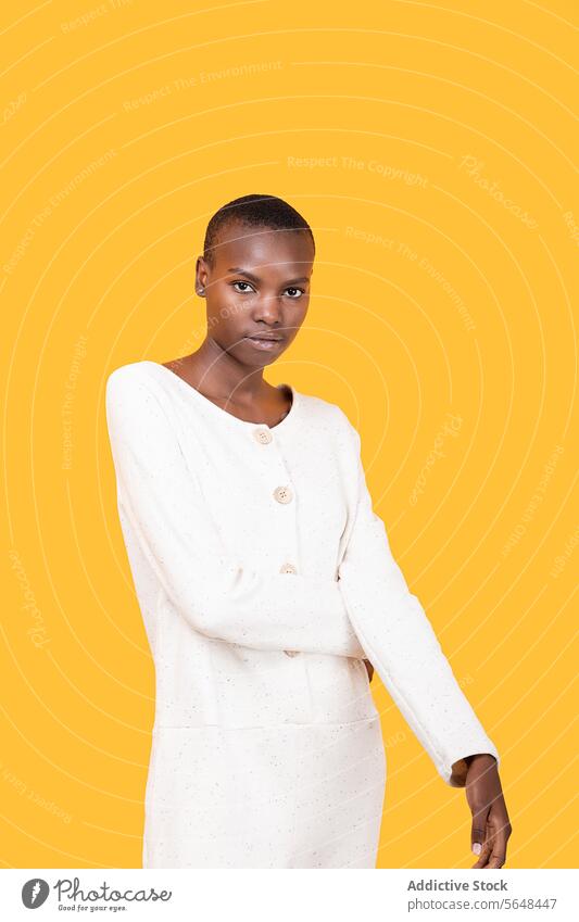 Confident black young woman isolated over yellow background confident portrait style serious emotion copy space african american short hair fashion attitude