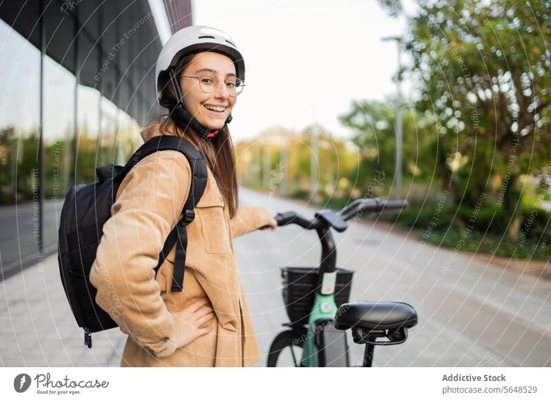 Smiling young woman with e-scooter outdoors helmet smile adult female electric city path sunlit cheerful standing safety transport transportation urban