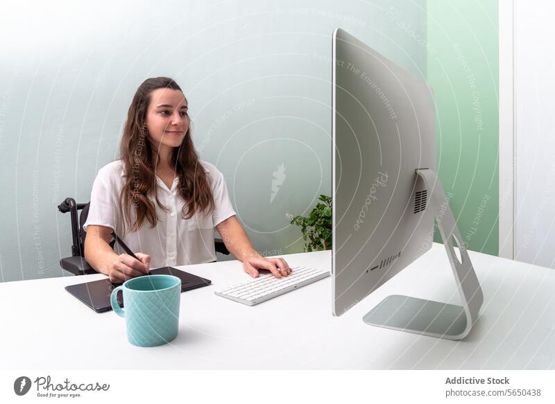 Modern Home Office Setup with Female Professional in wheelchair woman office home computer desktop tablet mug work professional modern sleek design trendy