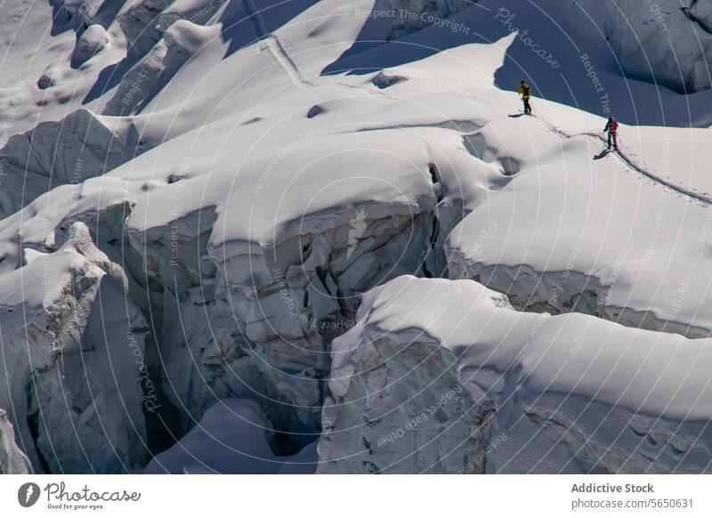 From above of anonymous skiers in warm clothes Traversing a Snow-Covered Glacier in Zermatt, Switzerland glacier snow ice ridge trail alpine terrain