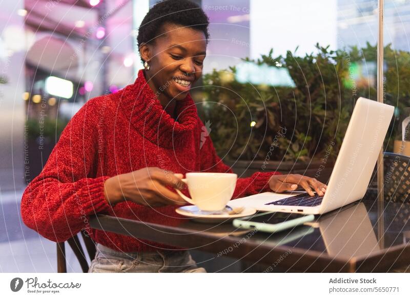 Freelancer black female working on laptop in cafe woman freelance using drink cappuccino coffee typing adult african american ethnic independent modern startup