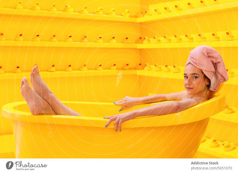 Woman in yellow bath relaxation bathtub rubber duck monochromatic room leisure chill serene tranquility rest pamper self-care comfort calm peaceful leisurely
