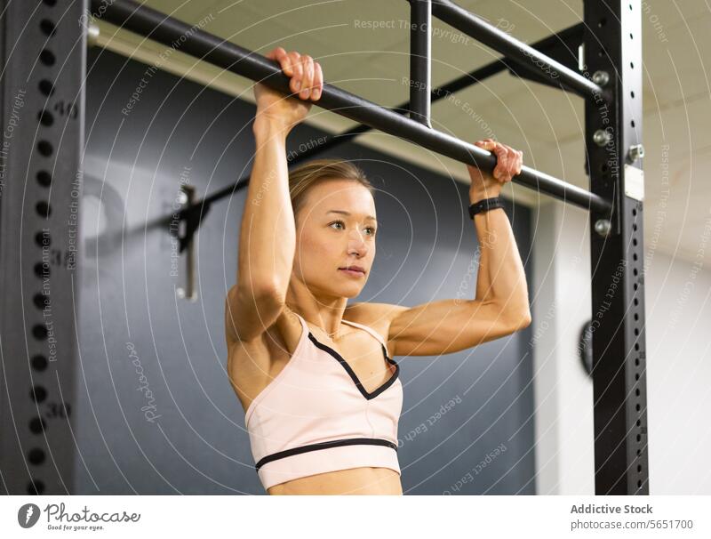 Woman in Activewear Hanging on a Pull Up Bar · Free Stock Photo