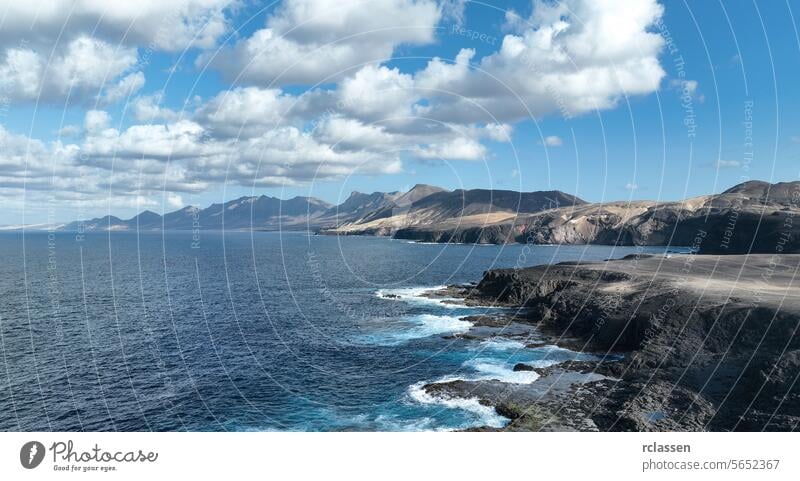 Cofete beach with endless horizon. Volcanic hills in the background and Atlantic Ocean. Cofete beach, Fuerteventura, Canary Islands, Spain. Arial view spain