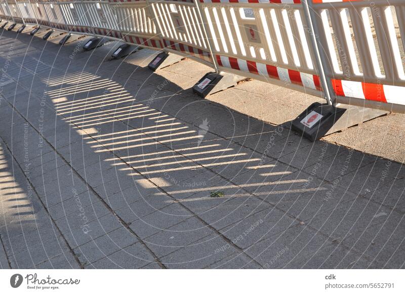 lengthwise | striped | long barrier fence on the sidewalk | road construction work Striped checks Checkered pavered off cordon Protective Grating