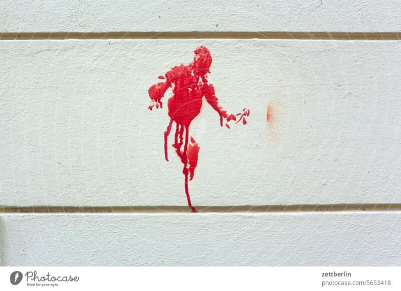 Red man (or something else) painting Graffiti mural painting Art Damage to property Vandalism Smeared sketch Drawing Children's drawing Man Human being person