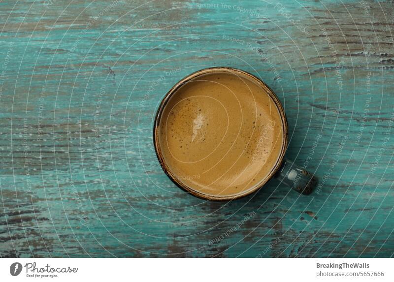 Espresso coffee cup on grunge blue table surface one full teal green drink beverage hot fresh refreshment energy caffeine crema perfect closeup copy space