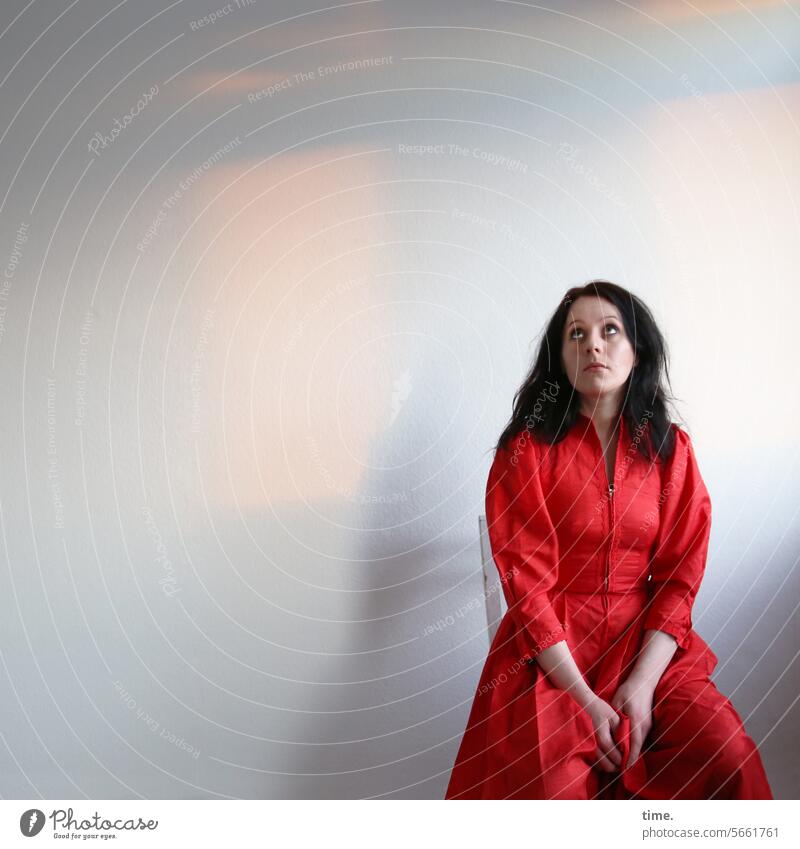 seated woman in red dress Woman Dress Red Sit Room Upward Long-haired Dark-haired Meditative Expectation feminine Feminine portrait Skeptical Observe look